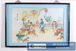 A decorative oriental shell picture in blue bordered frame.