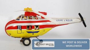 A clockwork tin plate Cote D`Azur helicopter by Joustra of France.