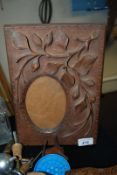 A carved wooden picture frame. 21cm x 30cm.