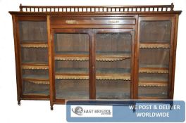 A large Victorian solid walnut breakfront library bookcase. The breakfront body having glass doors