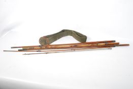 A vintage split cane fishing rod with canvas case