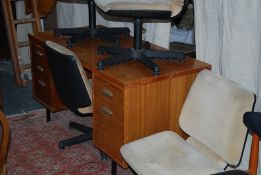 A retro 1970`s teak office desk. The ebonised metal legs supporting a good sized desk with a series