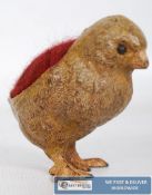 A bronze pin cushion in the form of a chick.