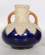 A 19th century twin handled ovoid bottle case having cobalt blue body with mottled neck. Possibly