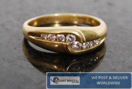 A 18ct gold and Diamond ladies cross over ring. The diamonds approx  25 pts being channel set to