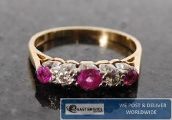 An 18ct gold ruby and diamond claw set half eternity ring. The channel set stones having 3 ruby`s