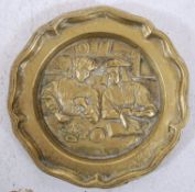 A 19th century heavy brass wall plaque / charger of continental flemish origin. The relief centre