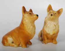 A pair of 1930`s plaster glazed decorative corgi dog figurines being 10cms high x 8cms long