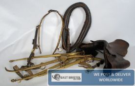 Equestrian Horse items to include a brass harness and leather saddle and neck ring etc