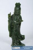 A carved jade style deity figure. 12.5cm tall.