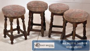 A set of 4 jacobean revival beech wood pub stools. The block and turned legs united by stretchers