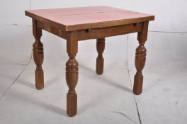 A 1930`s oak Air Ministry formica and oak draw leaf dining table. The turned legs supporting an