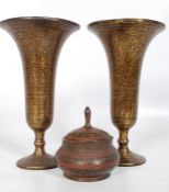A pair of brass vases along with a lidded (possibly Arabic) pot.
