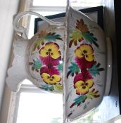 A hand painted wash bowl and jug with floral pattern