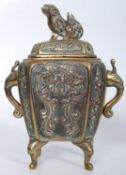 A Victorian incense burner made in brass with a bronze dog to top on shaped legs. 17cms High