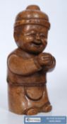 An carved wood oriental small child figure