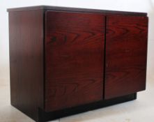 A Danish style rosewood veneer office filing cabinet. Inset plinth base with twin doors enclosing