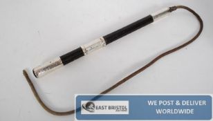 A silver banded horse riding crop