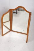An Edwardian satinwood tryptech dressing mirror. The satinwood frame having inset triple mirrors