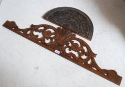 An early 20th century carved Indian hardwood wall plaque in half moon shape featuring elephants,