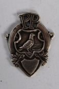 A Pigeon Pictorial hallmarked silver watch fob / medal. Decorative shield design showing pigeon atop