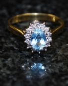 An 18ct gold aquamarine and diamond ladies solitaire ring
