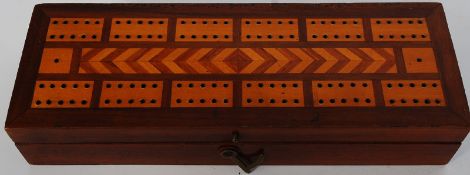 A Chas Goodall and Sons Cribbage board storage box, containing a set of bone and ebonised dominoes.
