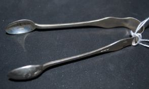 A pair of silver sugar tongs being hallmarked for London 1897 by Samuel Jacob. The tongs bowls being