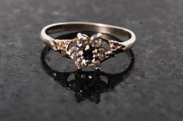 A silver hallmarked daisy ring having sapphire and diamond stones inset on clasp, Birmingham 1988