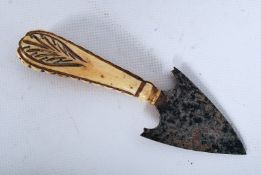 An African tribal hand spear having bone carved handle with trowel shaped spear head to the end.