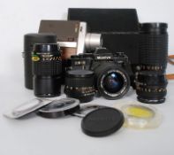 A Mamiya camera with various lenses with a Bell and Howell Cine.