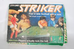 A vintage Parker Striker football game, along with a boxed Tudor Rose table soccer game.