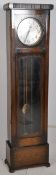 A large 1930's Art Deco oak Westminster chime longcase clock. The oak trunk with glazed door over