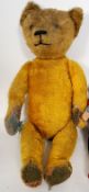 A large vintage straw filled mohair childrens teddy bear 55cm tall.