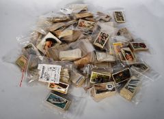A large quantity of loose cigarette cards to include people, views, flowers, flags, naval warships