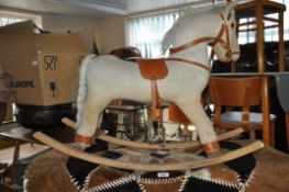 A vintage 1970's corduroy childs rocking horse on beech wood runners