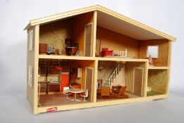 A 1970's Lundby dolls house with a quantity of original furniture, working electric lights, dolls,