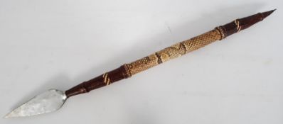 An African spear being double ended. Covered with hide and snakeskin being finished with other