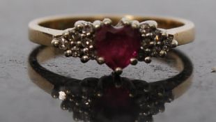 A Ruby and Diamond 9ct heart shaped stone ring with 6 cuts surround 2.3 grams Size J.