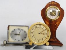 A collection of 3 small timepiece clocks