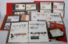 A collection of First Day covers in albums along with a Stanley Gibbons stamp album, and a