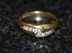 An 18ct gold channel waveset ring, with diamond stones. The diamonds approximately 25pts.