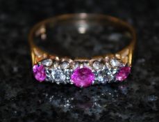 An 18ct gold claw set diamond and ruby ladies half eternity ring