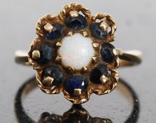 A 9ct Gold hallmarked ladies daisy ring set with amethyst and sapphire stone surround 21g.