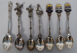 A collection of 7 silver spoons to include some continental , 3 x Worthing souvenir silver spoons