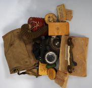 A British Army Issue cased gas mask with ointment pots, eye masks, ear plugs, field dressing, Gospal