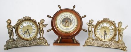 A pair of Splendex mantel clocks with cherubs along with a barometer.