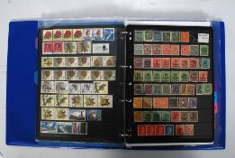 A stock book of Queen Victoria, Edward VII, George V and Queen Elizabeth II stamps.