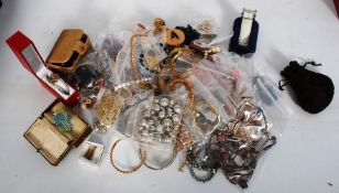 A good box of costume jewellery to include brooches, shell necklaces, watches, badges etc etc