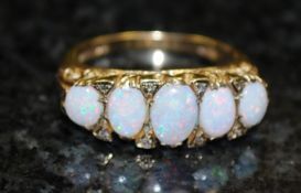 A 9ct gold channel set diamond and opal half eternity ring. The inset fire opals with diamond
